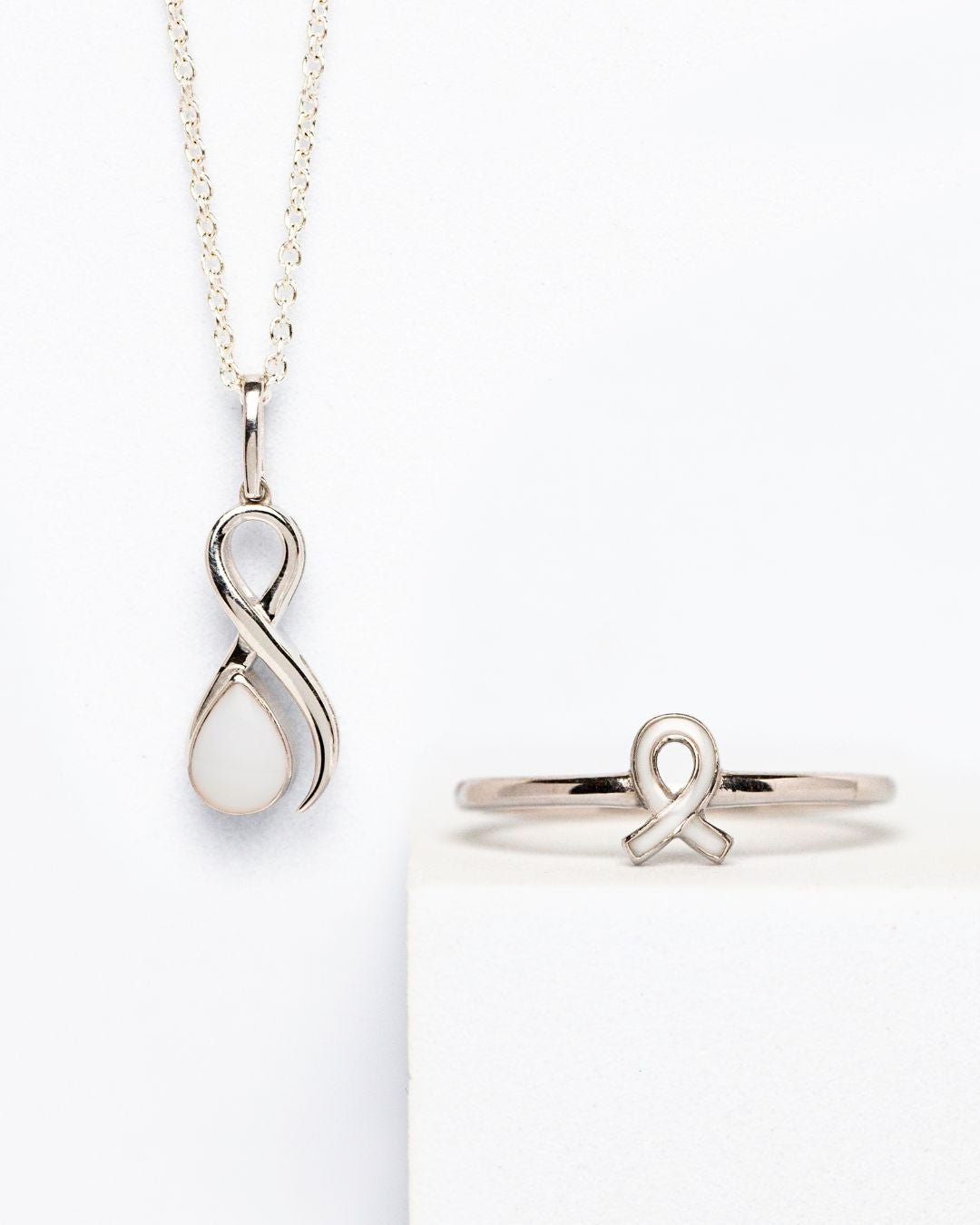 Breastmilk keepsake ribbon ring and pendant set in sterling silver for breast cancer awareness