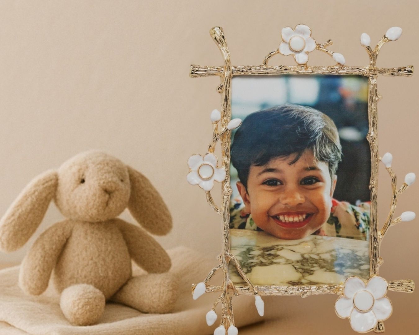 Decorative breastmilk keepsake picture frame with a child’s photo beside a soft toy, representing an alternative to breastmilk jewelry for moms who prefer something to display