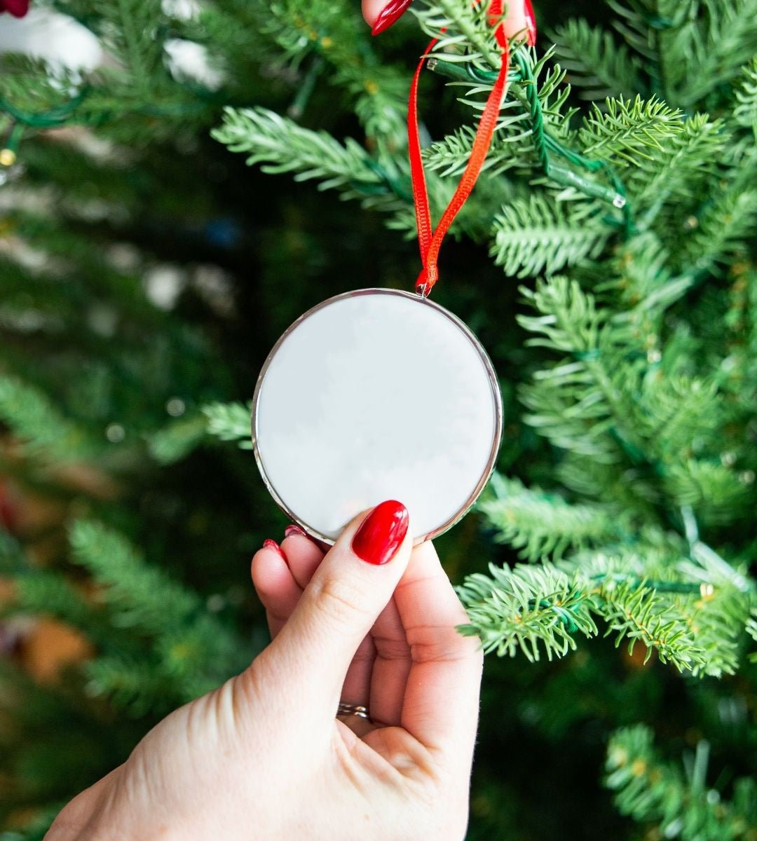 Full Moon Breastmilk Keepsake Ornament by Mamma’s Liquid Love hanging on a Christmas tree.