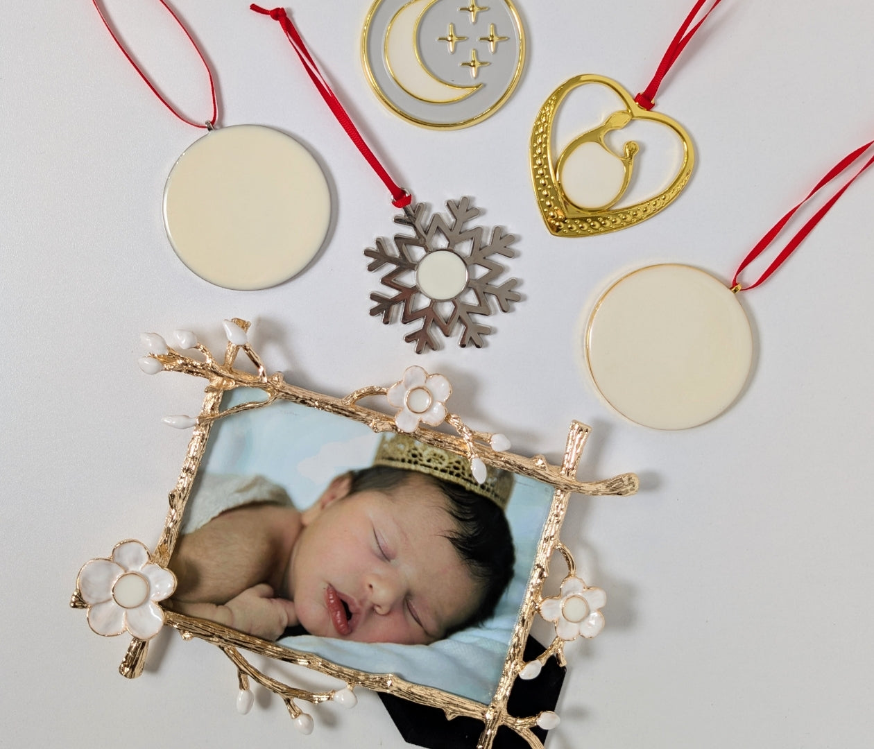 Gold floral Keepsake Frame with newborn photo surrounded by handcrafted breastmilk ornaments with red ribbons — Ultimate Keepsake Bundle by Mamma’s Liquid Love.