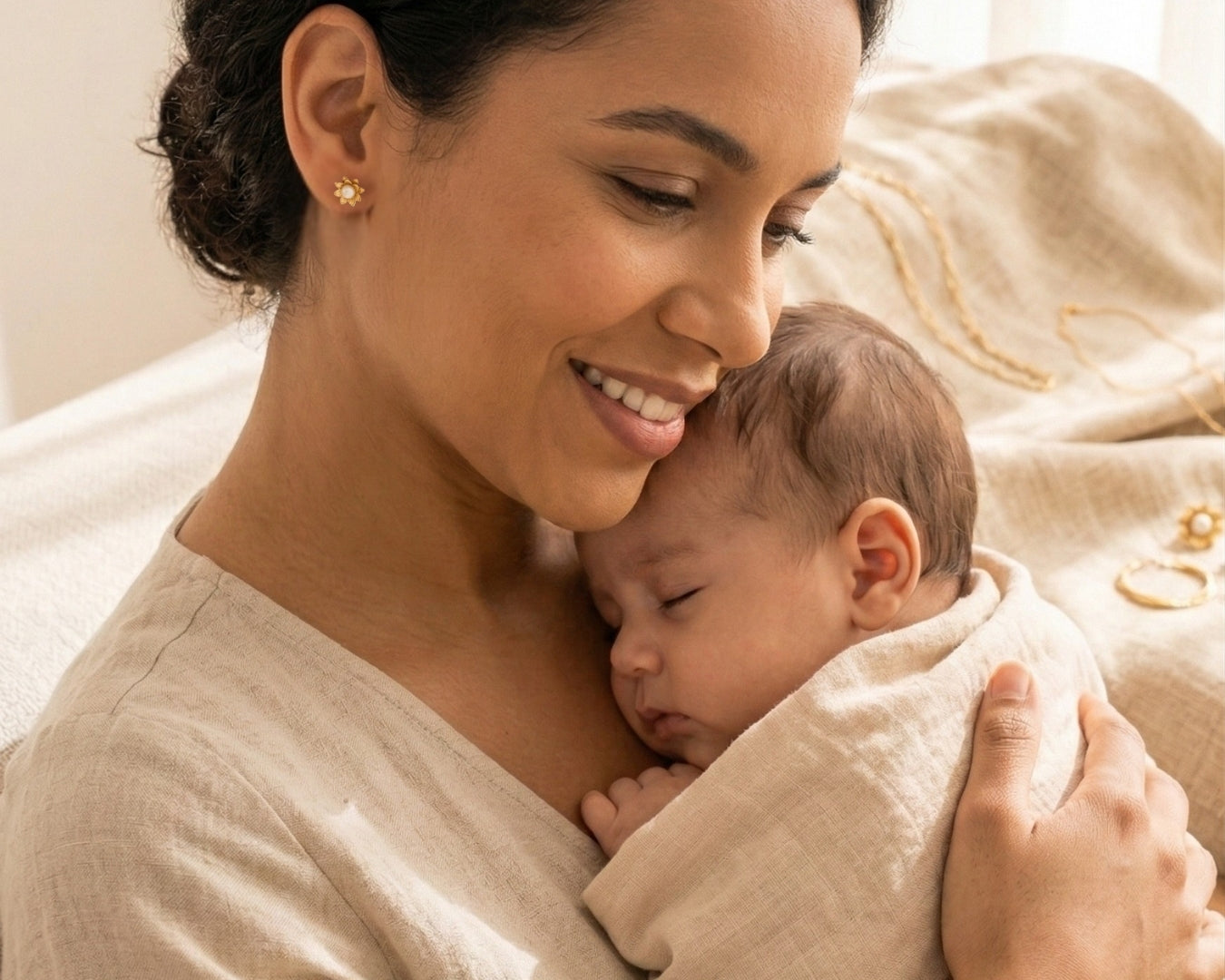Mother holding her newborn while wearing sunflower breastmilk stud earrings from the My Sunshine collection by Mamma’s Liquid Love